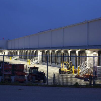 nighttime view of warehouse and yellow forklifts