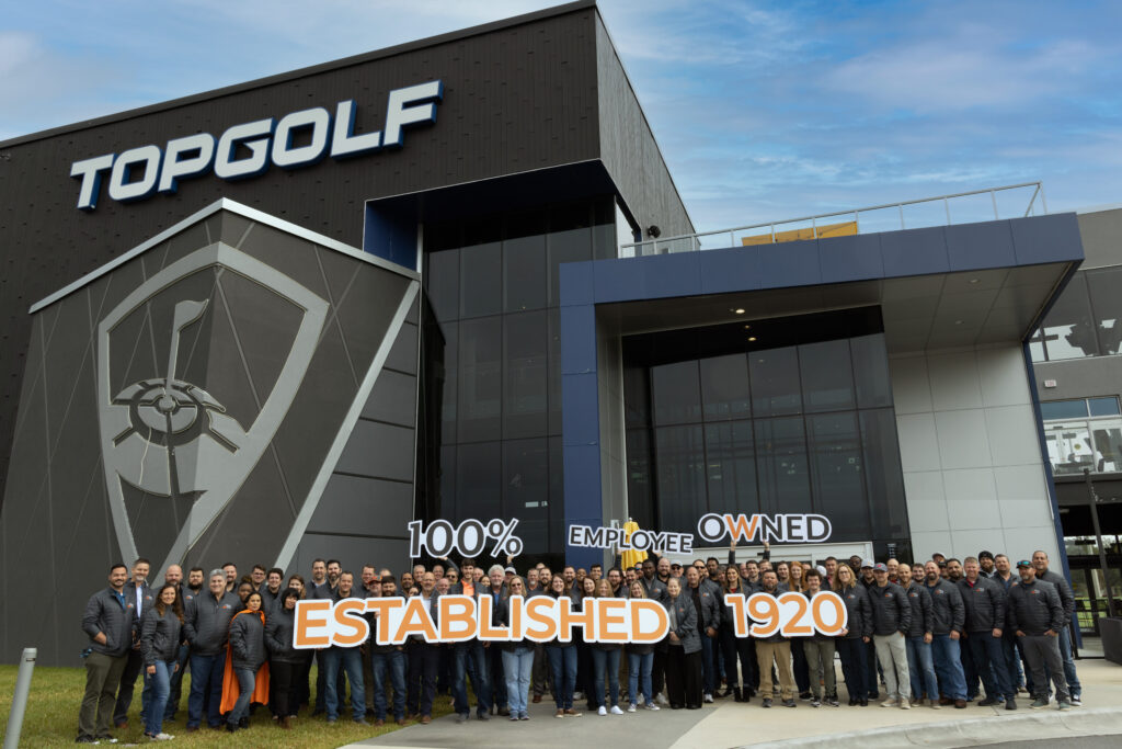 people in front of Top Golf building