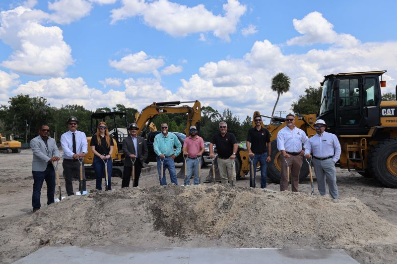 Groundbreaking ceremony with construction equipment.