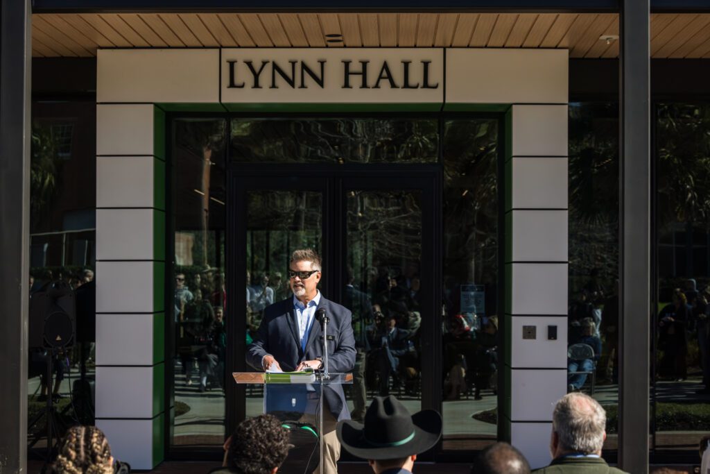 Man giving a speech at Lynn Hall entrance.